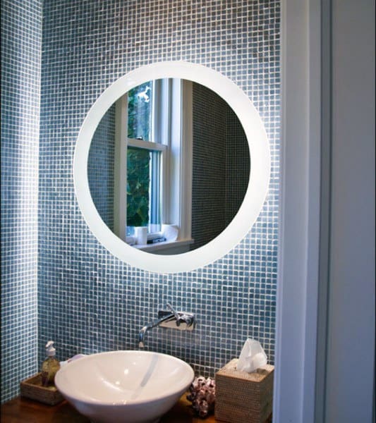 Small bathroom with round LED mirror, mosaic tile wall, and vessel sink.