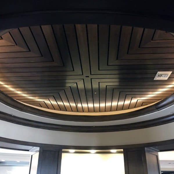 Circular wood ceiling with geometric pattern and integrated LED lighting for a modern look.