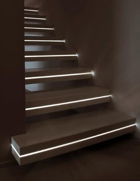 Minimalist staircase with glowing under-step lighting, adding elegance to the dark interior setting