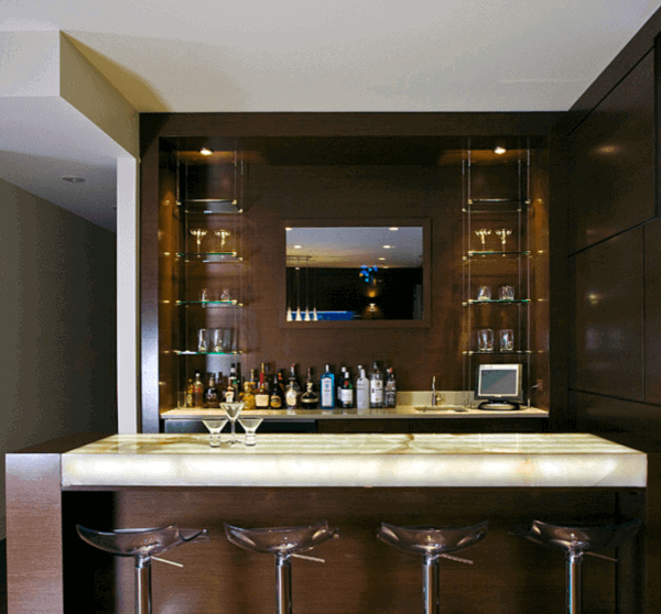 Illuminated bar top with LED lighting, glass shelves, and sleek acrylic bar stools in a stylish home bar.