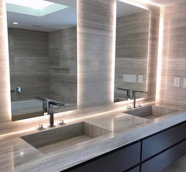 Double vanity bathroom with LED backlit mirrors and modern minimalist sinks.