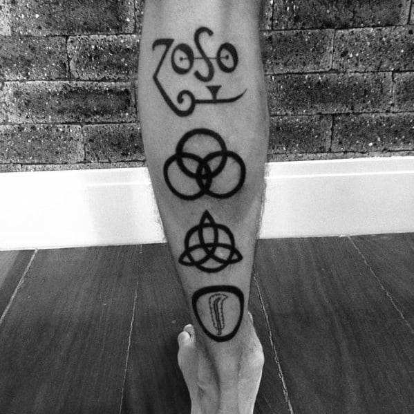 Bold black calf tattoo featuring the four iconic Led Zeppelin symbols: Zoso, Borromean rings, triquetra, and feather in a circle.