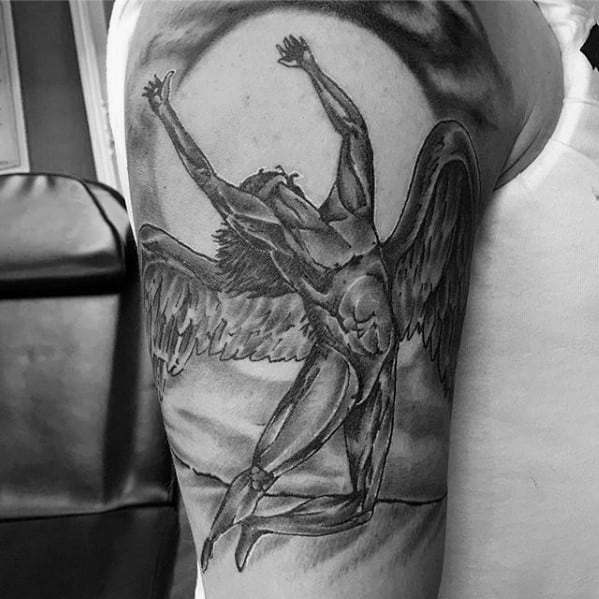 Upper arm tattoo of the iconic winged Icarus figure with arms raised, based on Led Zeppelin’s Swan Song Records logo.