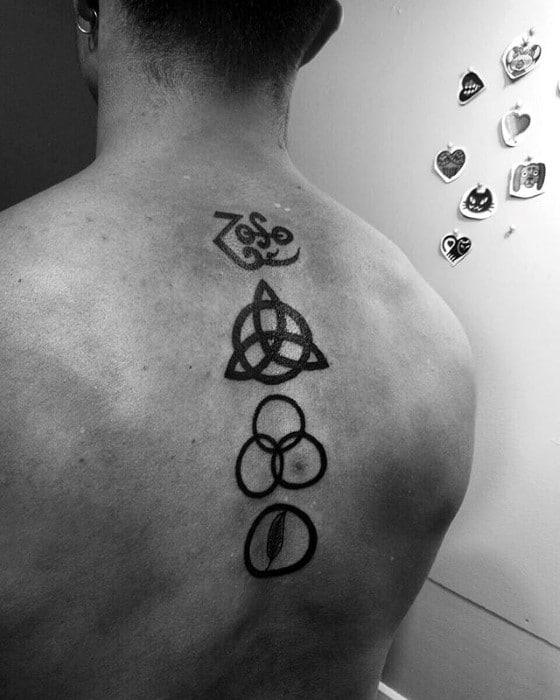 Back tattoo featuring the four Led Zeppelin symbols—Zoso, triquetra, Borromean rings, and feather—stacked vertically along the spine.