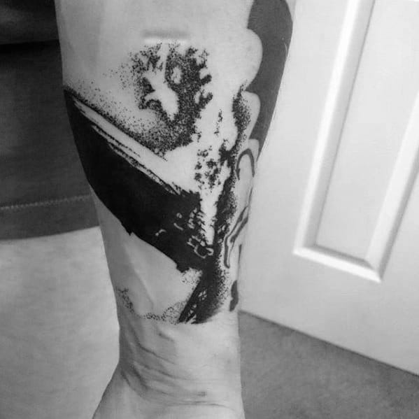 Black and white lower leg tattoo of a Zeppelin airship exploding, done in a bold dotwork and abstract style inspired by Led Zeppelin’s debut album.