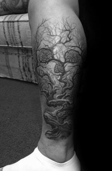 Detailed calf tattoo of twisting tree roots and branches forming a hidden skull, blending organic flow with subtle dark imagery.
