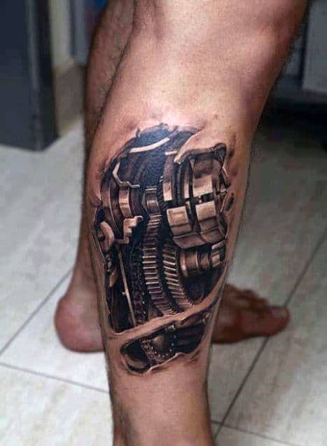 Realistic tattoo of mechanical gears on a person's calf, resembling exposed inner workings