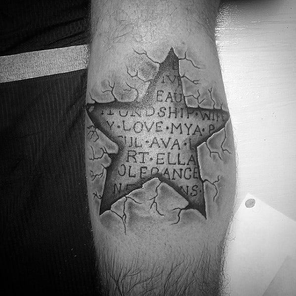 3D star tattoo on leg with cracked skin effect, revealing engraved names and words like friendship and love beneath the surface.