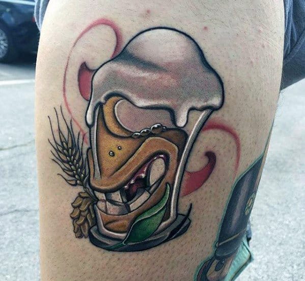 Colorful tattoo of a beer mug with a mischievous face, overflowing foam, and surrounded by barley and hops, done in a bold, cartoonish style.