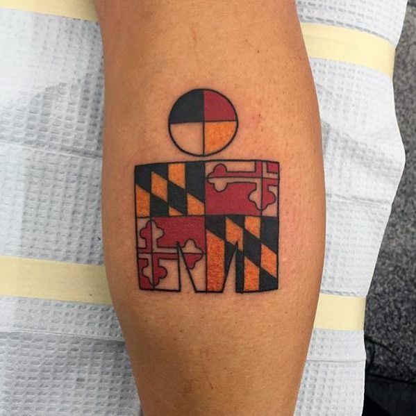 Ironman logo tattoo filled with the Maryland state flag pattern, featuring bold red, gold, black, and white segments with clean geometric lines.