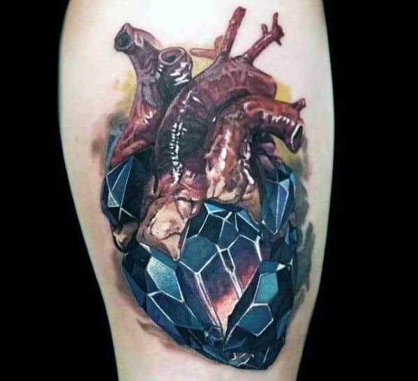 Realistic 3D tattoo of an anatomical heart merging with a faceted black crystal, symbolizing resilience and strength in a bold design.