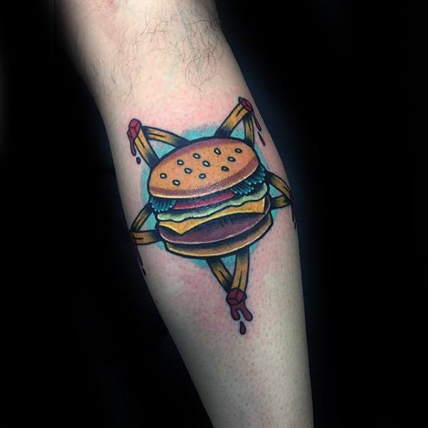Cheeseburger tattoo inside a pentagram with dripping elements on a person's arm