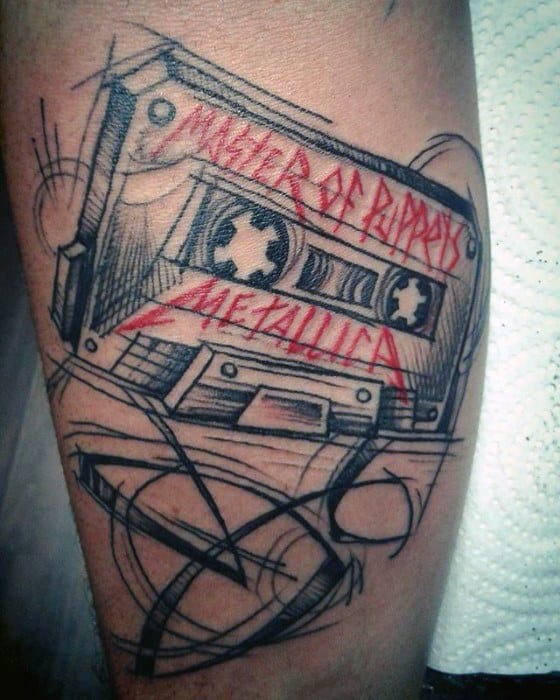Sketch-style tattoo of a cassette tape labeled Master of Puppets and Metallica in red, combining retro vibes with a raw, artistic look.