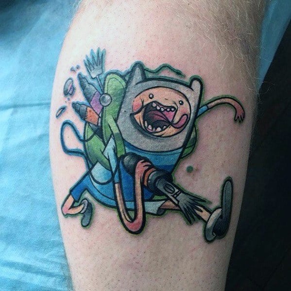 Adventure Time tattoo of Finn running with a backpack full of weapons and supplies, inked on the lower leg.