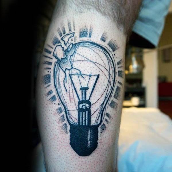 Creative tattoo of a cracked light bulb with a tiny figure swinging a hammer inside, symbolizing breaking limits or sparking rebellion.