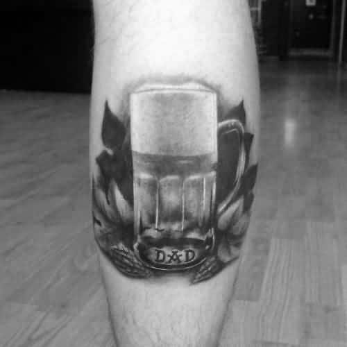 Black and gray tattoo of a realistic beer mug surrounded by hops and leaves, with the initials "D&D" engraved at the base for a personal touch.