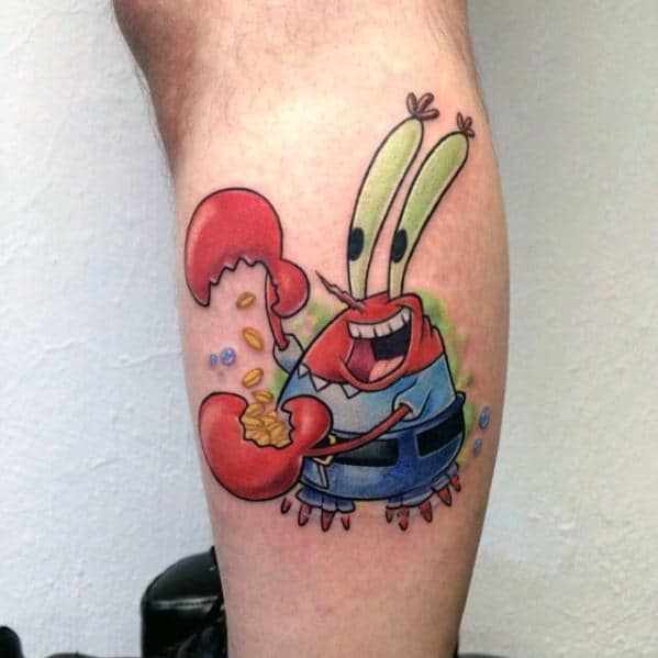 Bright tattoo of Mr. Krabs on the calf, happily clutching gold coins with a big grin and vibrant cartoon colors.