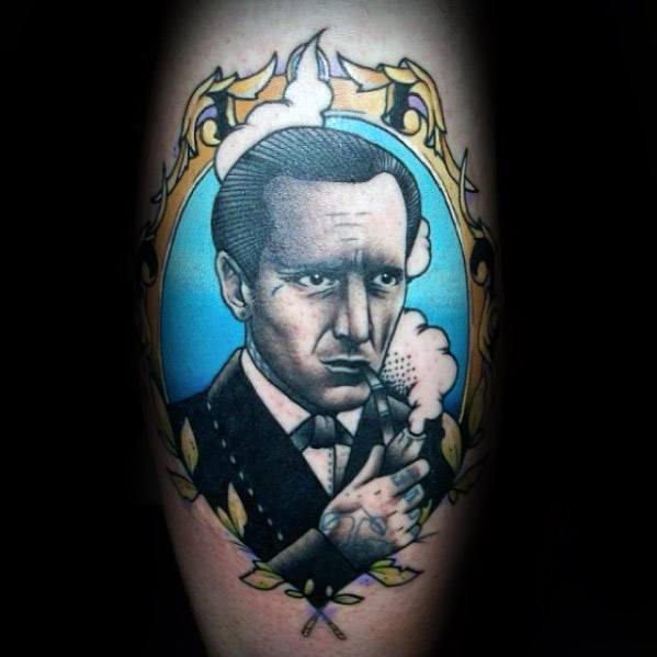 Tattoo of Sherlock Holmes in a suit, encased in an ornate frame against a striking blue backdrop