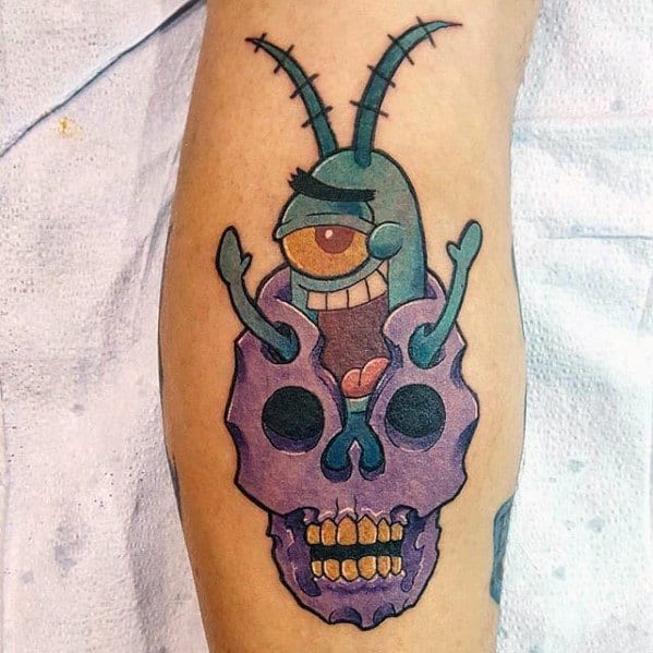 Tattoo of Plankton bursting out of a purple skull with a sinister grin, combining cartoon mischief with a dark twist.
