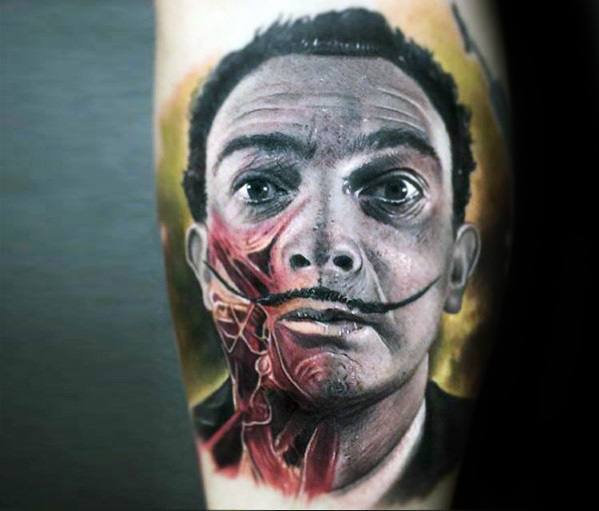 Striking Salvador Dali tattoo blending realism with anatomical art, revealing facial muscles beneath the skin for a surreal, thought-provoking effect.