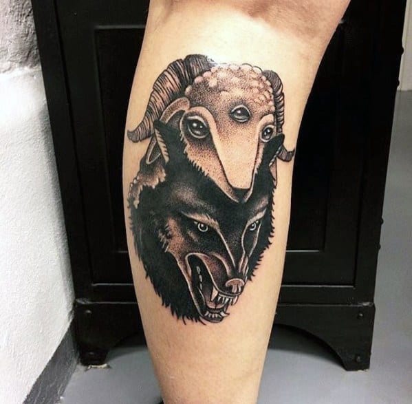 Tattoo of a wolf and a ram on a person's calf