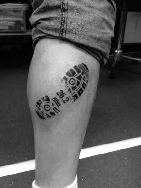 Realistic shoe print tattoo with “26.2 miles” inside, symbolizing every step taken to complete a marathon.