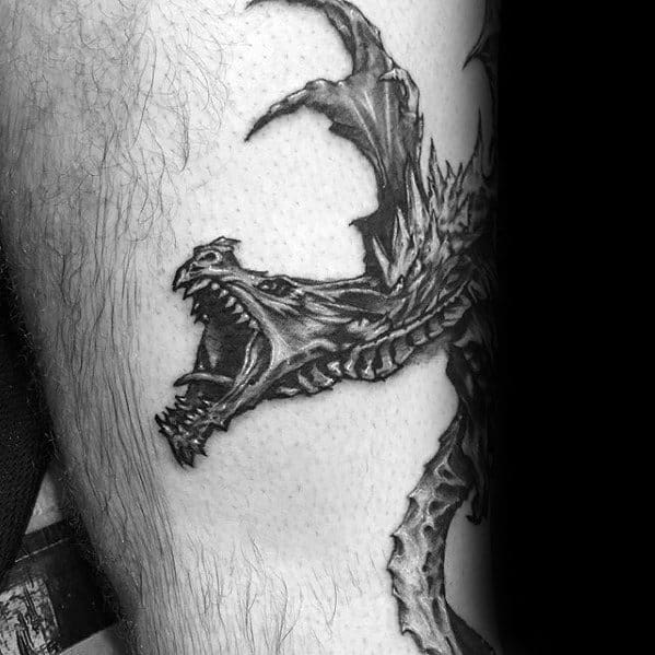 Realistic Skyrim dragon tattoo featuring intricate scales, sharp claws, and a fierce roaring expression, masterfully shaded for depth and texture.