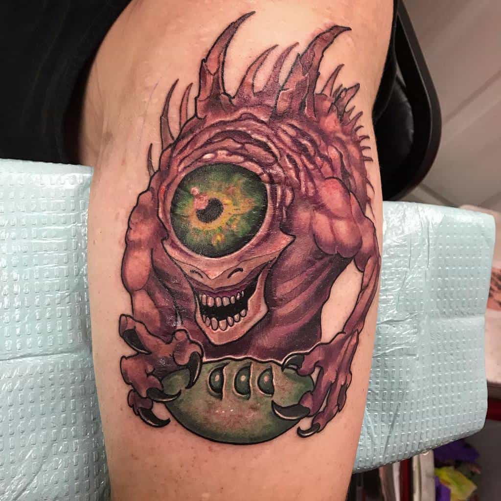 Detailed tattoo of a Beholder with a glowing green eye and sharp fangs, a feared D&D enemy