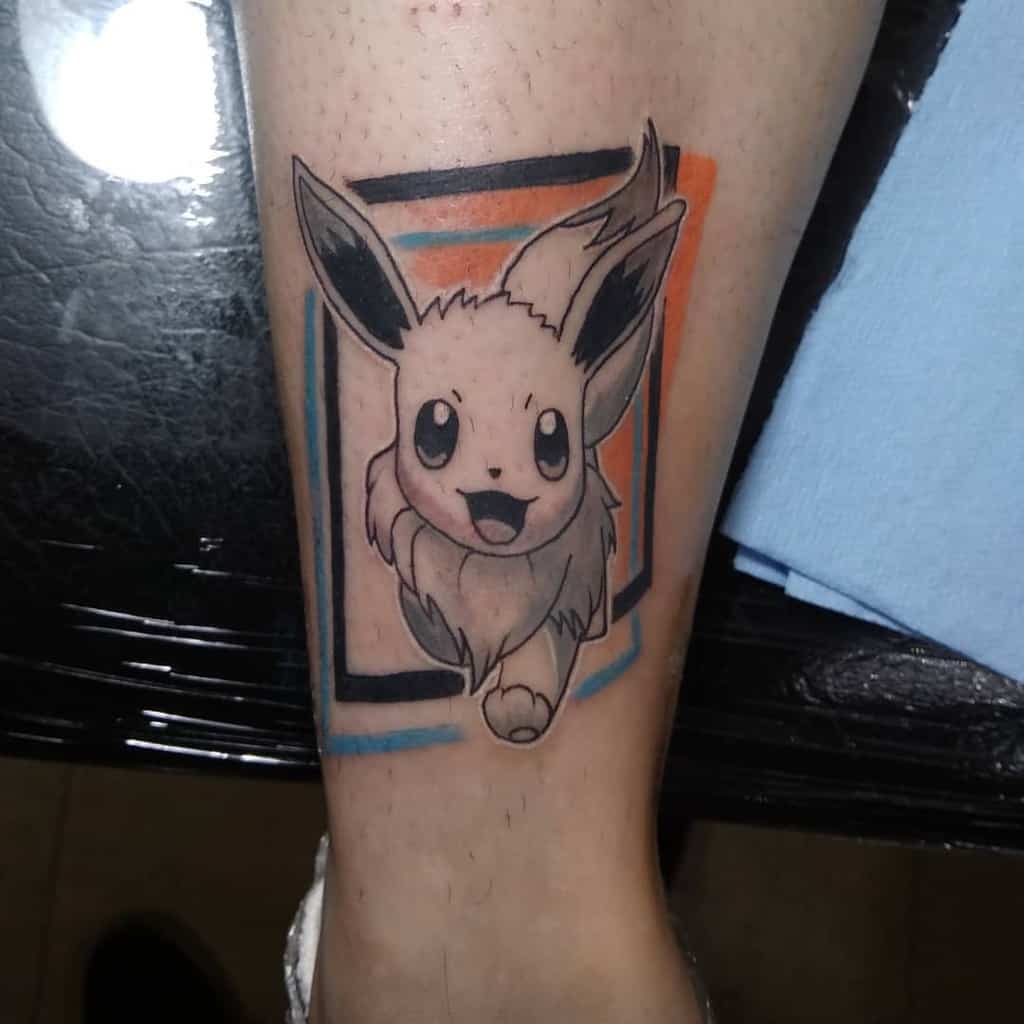 Stylish Eevee tattoo with bold black outlines, framed by orange and blue geometric accents for a modern look