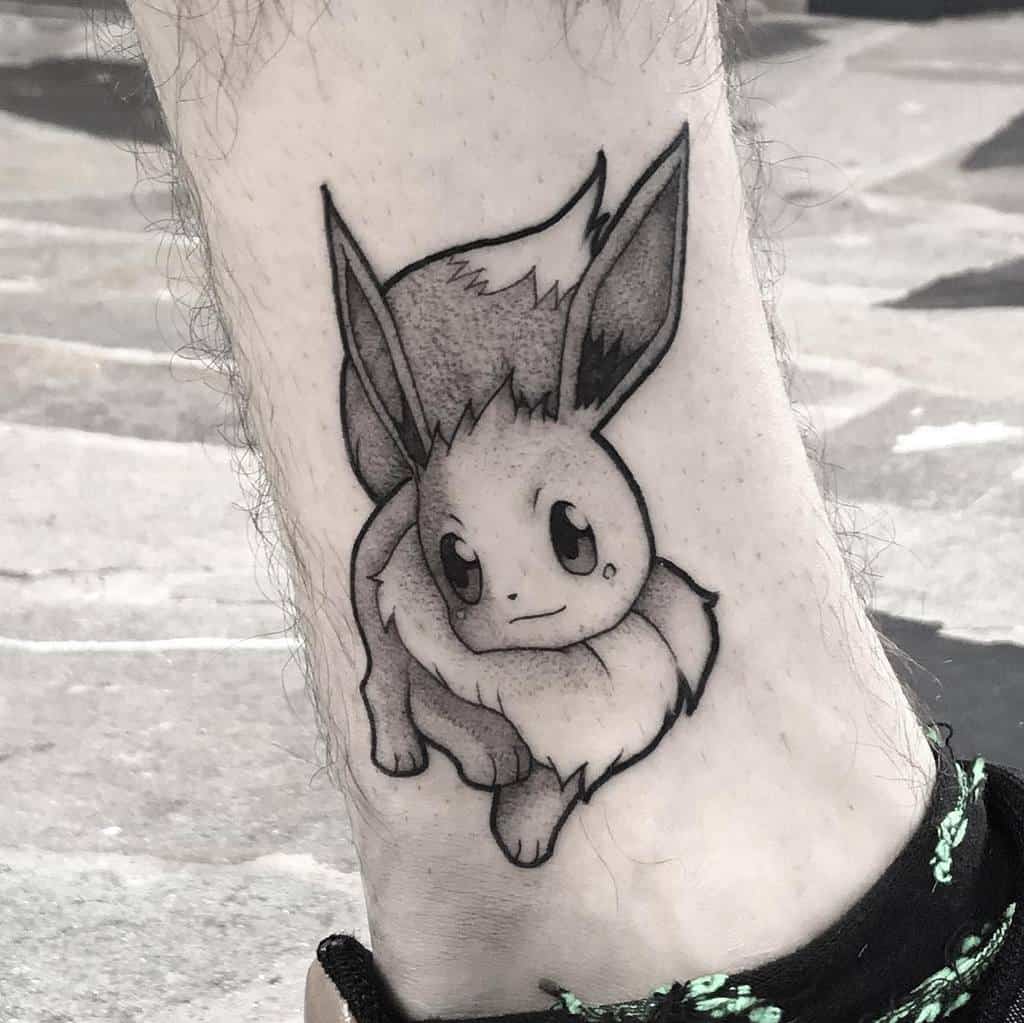 Minimalist black and grey Eevee tattoo with detailed dot shading, creating a sleek and refined design