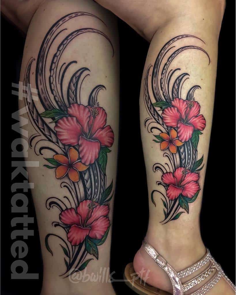 Leg tattoo featuring vibrant Hawaiian flowers with hibiscus and plumeria, accented by black swirling tribal patterns