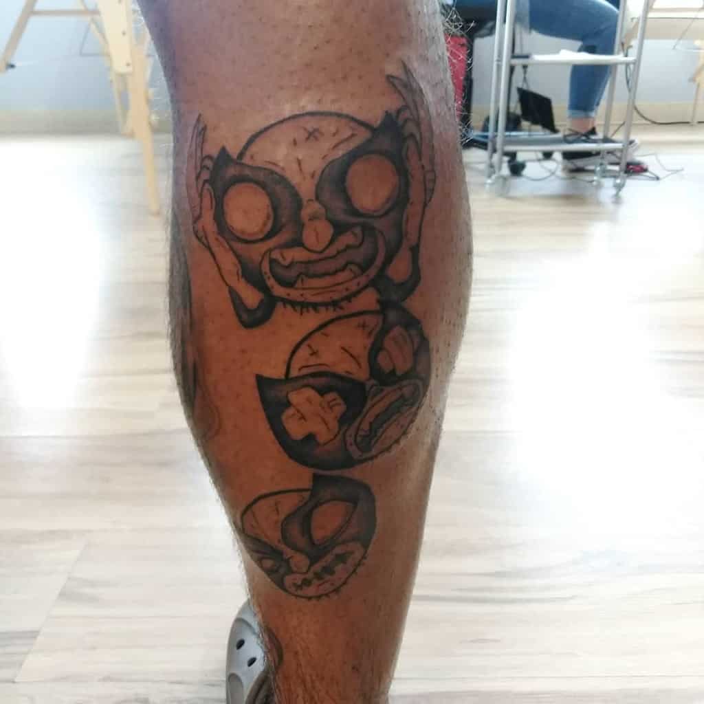 Leg tattoo of stylized skulls in a vertical arrangement