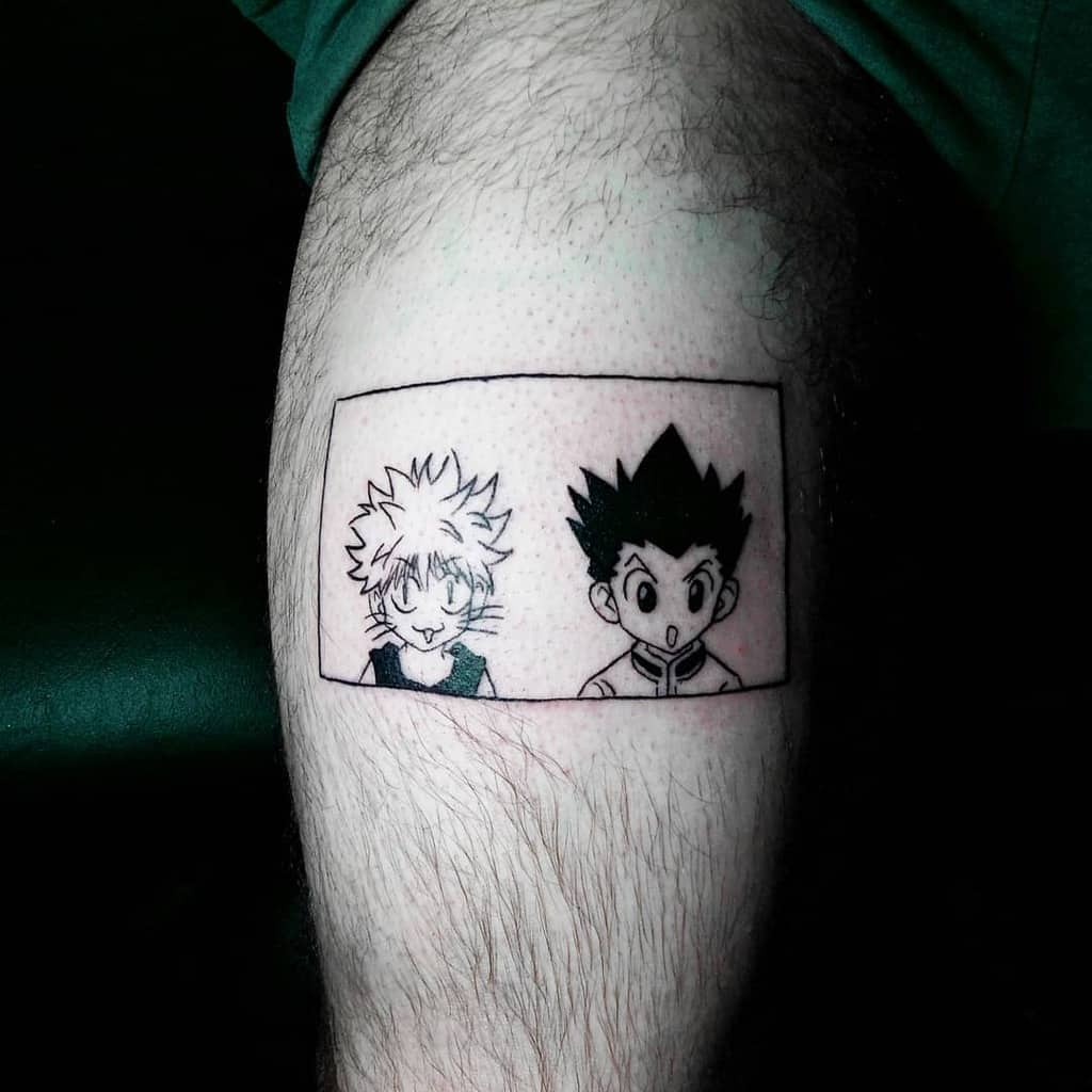 Black and white tattoo of Gon and Killua from Hunter X Hunter, depicted in a comic-style frame on a person's thigh