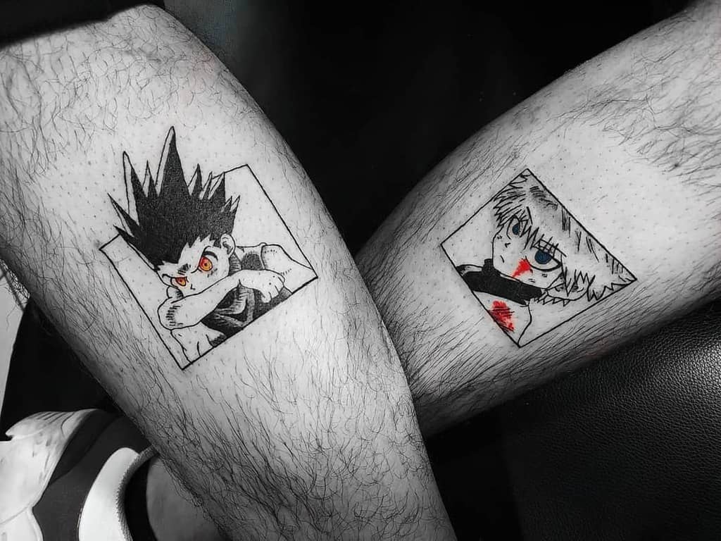 Black and white tattoos of Gon and Killua from Hunter X Hunter, framed in squares, on each of the person's lower legs