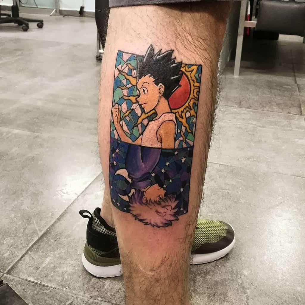 Colorful Hunter X Hunter tattoo of Gon and Killua in a stained-glass style on a lower leg