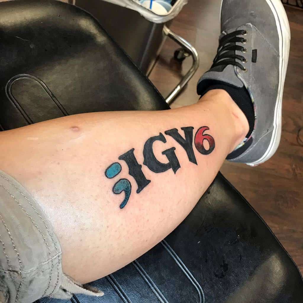 Tattoo on a leg reads ";IGY6" in bold black and red letters