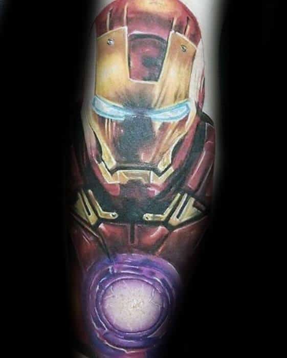 Iron Man tattoo featuring a detailed portrait of his helmet with glowing blue eyes, highlighting his chest arc reactor in vibrant purple hues.