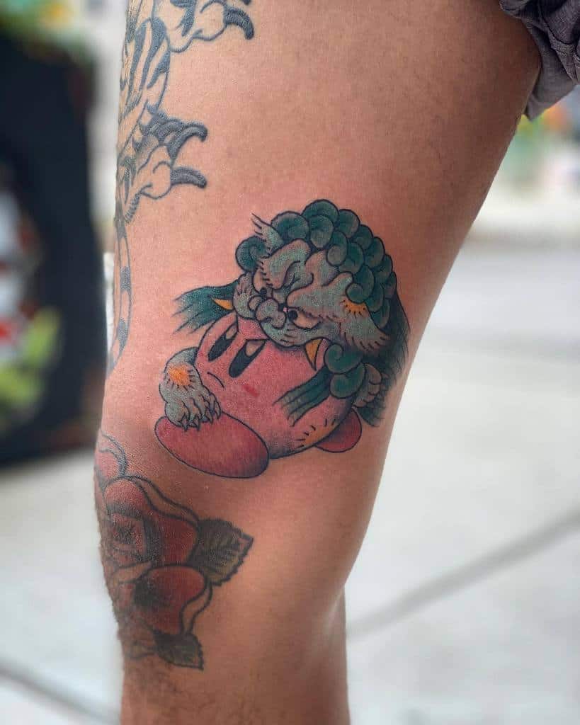 Kirby tattoo fused with a traditional Japanese guardian lion (Shishi), featuring fierce details, textured fur, and bold shading
