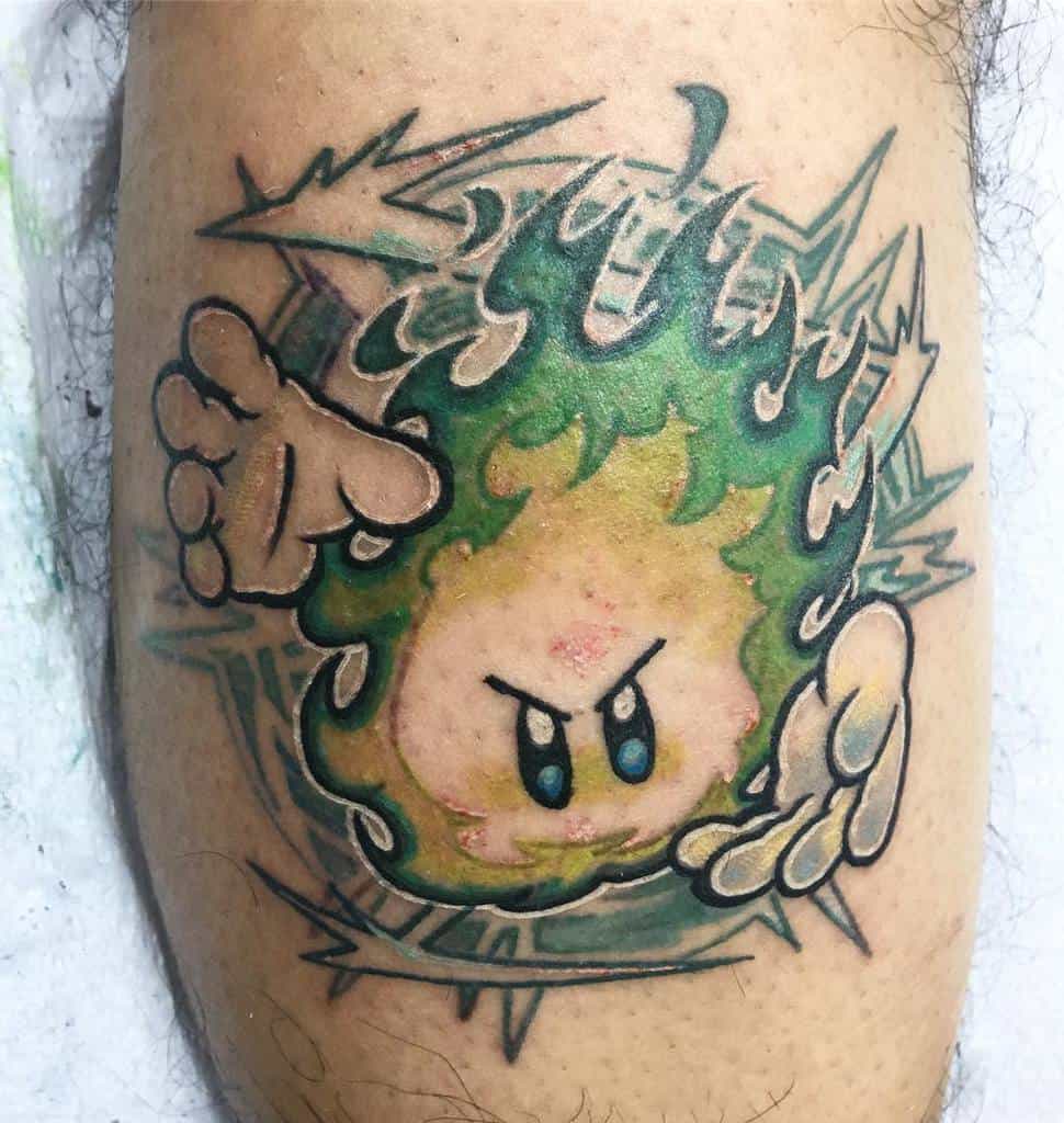 Kirby tattoo in a fiery green form with an intense expression, surrounded by sharp energy bursts and hand reaching out