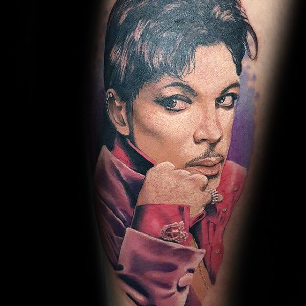 A stunningly vibrant tattoo of Prince in his iconic pose, showcasing detailed facial features and elegance.
