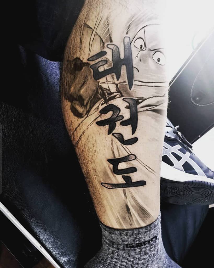 A dynamic black and gray tattoo of Saitama from One Punch Man mid-punch, featuring bold Korean characters integrated into the design