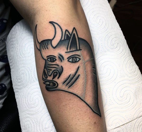 Tattoo of the bull from Picasso’s *Guernica*, featuring bold outlines, intense eyes, and smooth shading for a powerful, symbolic look.