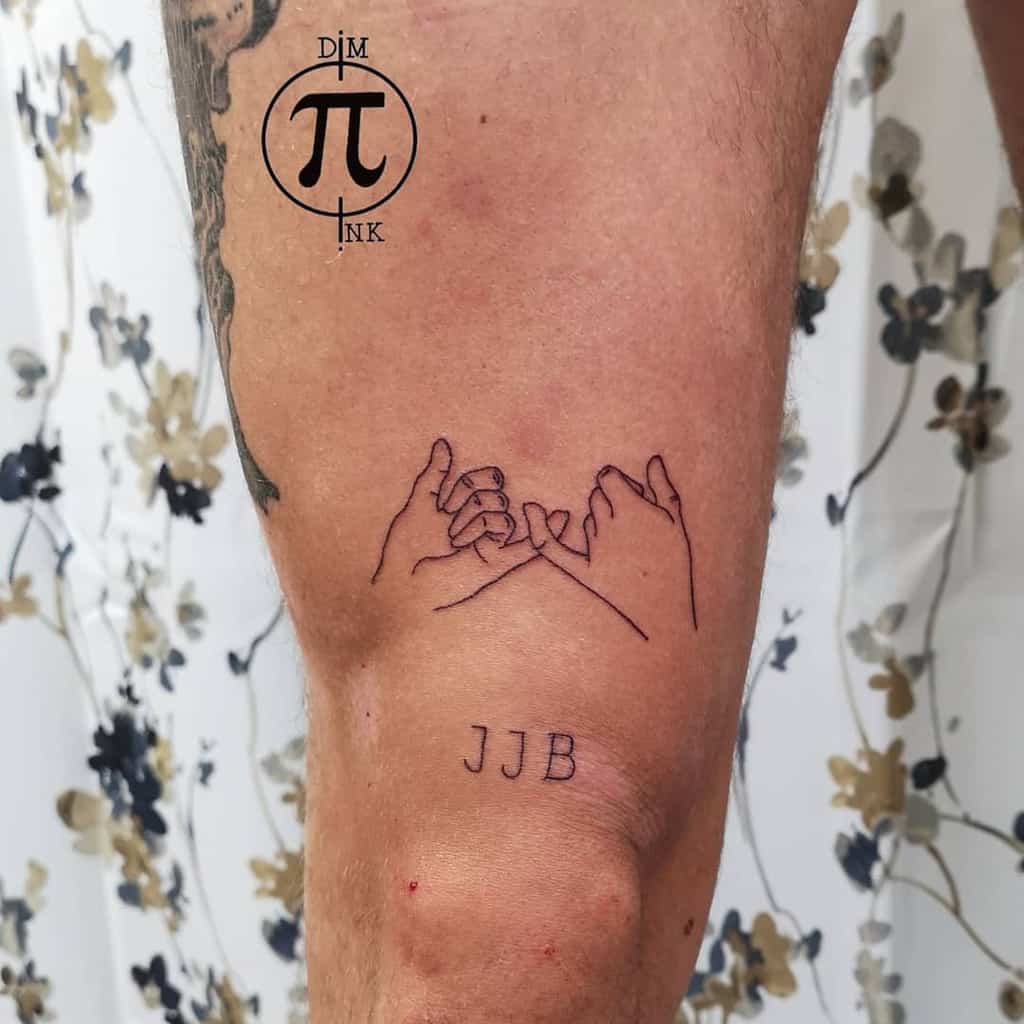 Pinky promise tattoo with simple line art on a leg, accompanied by the initials "JJB" below, displayed against a floral backdrop