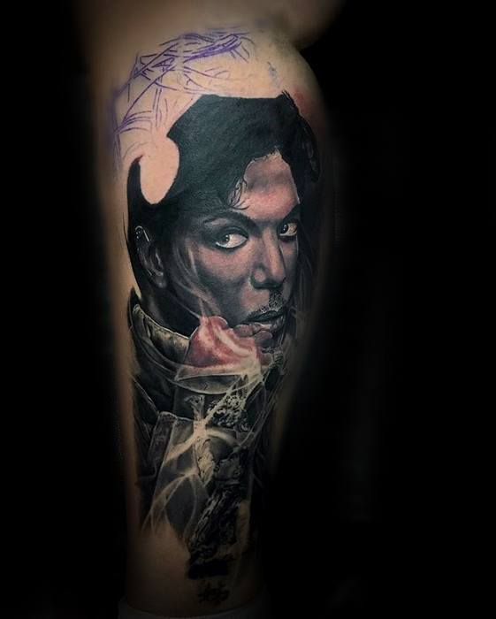 A captivating tattoo of Prince, blending realism with artistic abstraction, highlighting his enigmatic gaze
