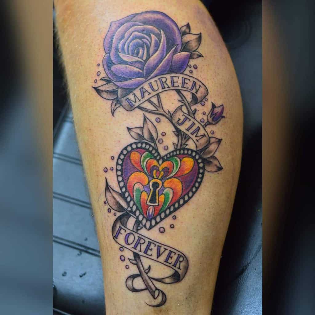 Leg tattoo features a vibrant purple rose at the top, accompanied by a colorful heart with an intricate lock design and the names "Maureen" and "Jim" in a flowing ribbon with the word "FOREVER" at the bottom