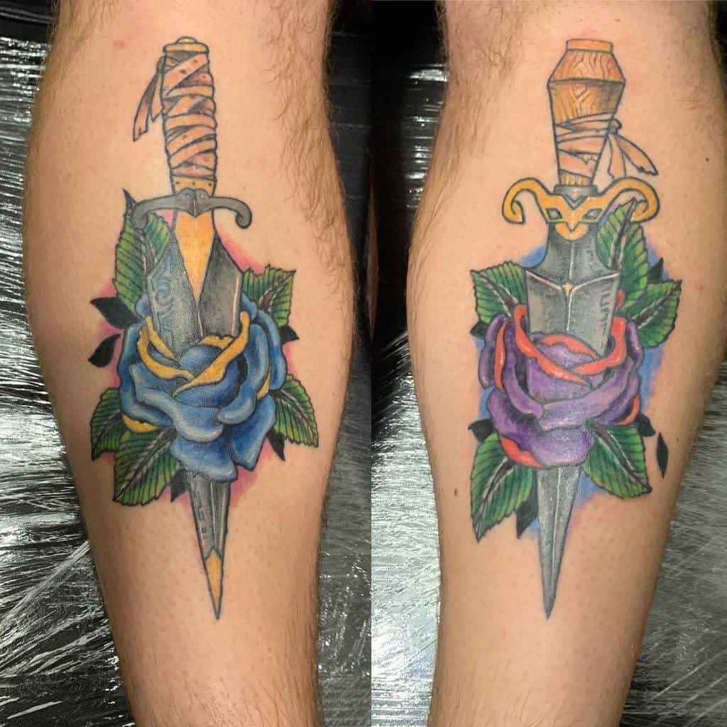 Two calf tattoos of daggers through roses; one blue, one purple