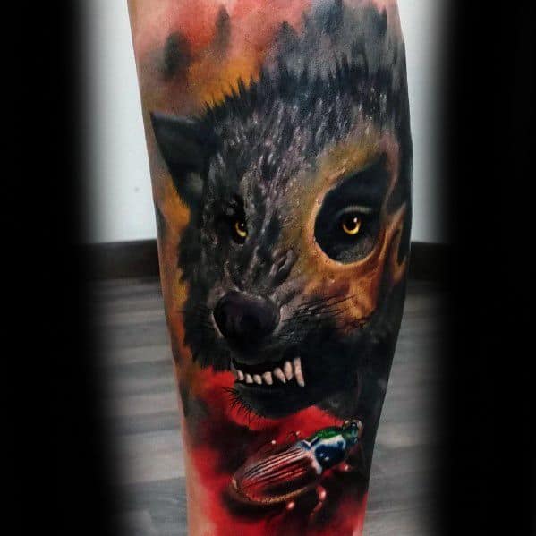 Realistic hyena tattoo with intense golden eyes and a subtle snarl, set against a fiery background and detailed with a colorful beetle near the base.