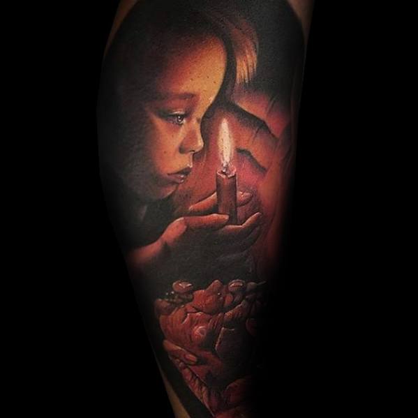 Tattoo of a child holding a lit candle, with roses below, set against a dark background