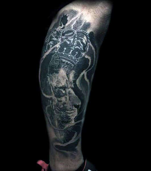 Leg Sleeve Tattoo Of Lion With Crown Design On Man