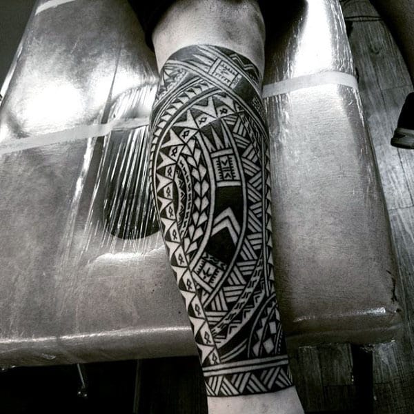 Leg Sleeve Tattoo On Male Of Tribal Design